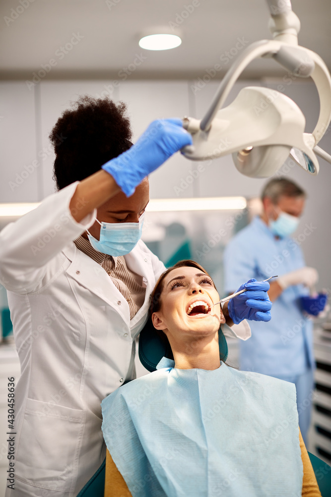 Dentist examining patient